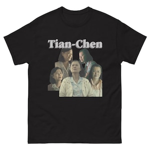 May include: Black t-shirt with the text "Tian-Chen" in a gray, stylized font. The shirt features a collage of five women's faces.