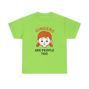 May include: A bright green t-shirt with the text "GINGERS ARE PEOPLE TOO" in orange. The design includes a cartoon illustration of a person with red hair, heart-shaped eyes, and pigtails.