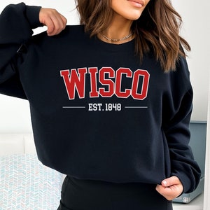 May include: Black sweatshirt with red text that reads "WISCO EST. 1848".