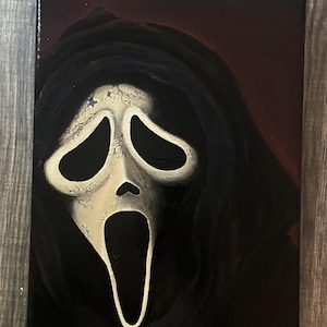 May include: A canvas painting depicting the Ghostface mask from the Scream film franchise. The mask is off-white with black eye and mouth openings, set against a black hooded robe and a dark red backdrop.