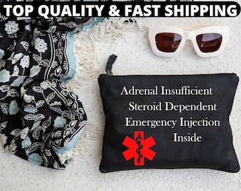 May include: Black canvas pouch with white text that reads "Adrenal Insufficient, Steroid Dependent, Emergency Injection Inside". A red medical star of life symbol is in the center of the pouch.