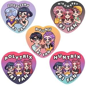 May include: A collection of heart-shaped stickers featuring cartoon illustrations of groups of people. Each sticker has a different name at the top and the words "#1 FAN" at the bottom. The stickers have a variety of colors.