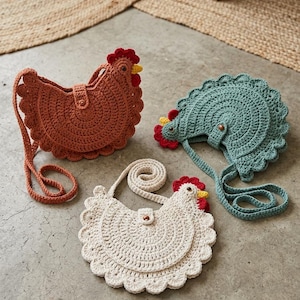 May include: Three crochet chicken-shaped purses in shades of brown, seafoam green, and cream. Each purse features a red comb, yellow beak, and a scalloped edge. The purses have long straps and a button closure.