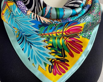 May include: A turquoise, yellow, black, and red silk scarf with a floral and zebra print.