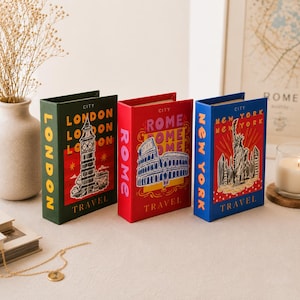 May include: Three travel-themed boxes in green, red, and blue. Each box features a city name: London, Rome, and New York. The London box shows a clock tower, the Rome box depicts the Colosseum, and the New York box displays the Statue of Liberty.