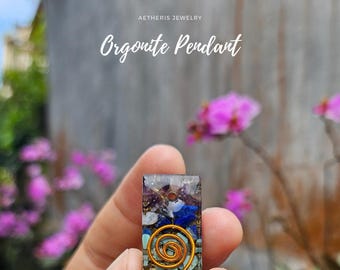Può includere: Un ciondolo in orgonite Aetheris Jewelry con un design a filo di rame e vari cristalli colorati incastonati in resina trasparente.