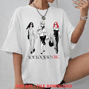 May include: White t-shirt featuring a graphic of three stylish women in black and white outfits, with red accents. The text "YOU LOOK SO CHIC" is printed below the figures. The shirt is a casual, oversized fit.