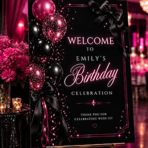 Op de afbeelding: Een zwart rechthoekig verjaardagsbord met roze en zwarte ballonnen, een grote zwarte satijnen strik en roze neon-stijl tekst: WELCOME TO EMILY'S Birthday CELEBRATION THANK YOU FOR CELEBRATING WITH US! Het ontwerp bevat roze glitters en accenten.