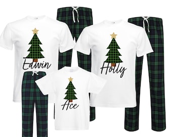 May include: A set of three white t-shirts with a green and black plaid Christmas tree design and the names "Edwin", "Holly", and "Ace". The shirts are paired with matching green and black plaid pajama pants.
