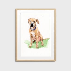 May include: Watercolor painting of a tan dog with a blue collar, sitting on green grass. The dog is centered in a wooden framed print against a white background. The artwork is a portrait of a dog.