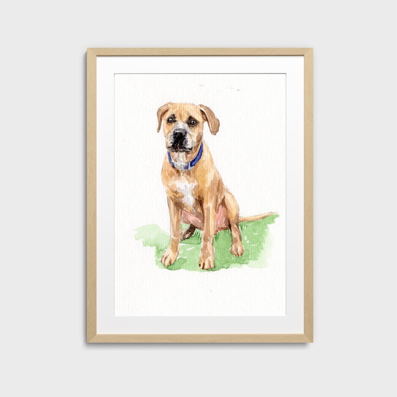 May include: Watercolor painting of a tan dog with a blue collar, sitting on green grass. The dog is centered in a wooden framed print against a white background. The artwork is a portrait of a dog.