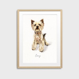 May include: Watercolor portrait of a Yorkshire Terrier dog in a wooden frame. The dog has tan and gray fur, a brown collar, and the name "Cinny" written below. The artwork is set against a white background.