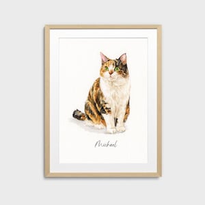 May include: Watercolor painting of a calico cat with green eyes, sitting upright. The cat has a mix of brown, orange, and white fur. The artwork is framed in a light wood frame, with the name "Michael" written below the cat.