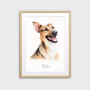 May include: Watercolor portrait of a happy dog, with brown and white fur, in a wooden frame. The dog is smiling with its tongue out. The name "Tucker" is written in cursive below the dog.