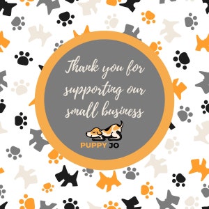 May include: A thank you card with a gray circle and orange border. The text inside the circle says "Thank you for supporting our small business." There is a cartoon dog sleeping in the bottom of the circle. The text "Puppy Jo" is below the dog. The background is white with a pattern of paw prints and small dogs.