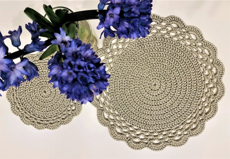 May include: A set of three ceramic mugs with a speckled, matte finish. The mugs are in shades of cream, light gray, and dark gray. Each mug has a simple, minimalist design, perfect for coffee or tea.