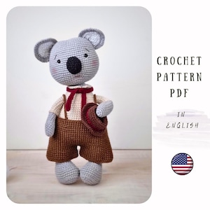 May include: Crochet pattern PDF in English for a gray koala wearing a red bow tie and brown overalls holding a brown hat. The pattern includes an American flag.