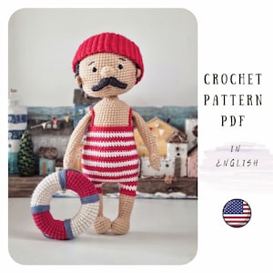 May include: Crochet pattern PDF in English for a red and white striped swimsuit wearing amigurumi doll with a red hat and a black moustache. The doll is holding a red and white life preserver.