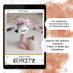 May include: A digital tablet displays a tutorial for crafting a deer figurine. The deer is light brown with white accents, a floral crown, and a closed-eye expression. Text includes "USTcake", "MACH DEIN REHKITZ", and instructions in German.