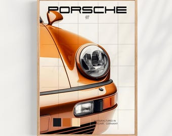 May include: Orange Porsche 911 print with the text "PORSCHE 911" at the top. The print features the front of the car, including the headlight and turn signal. The print is in a wooden frame.