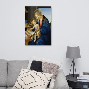The intimate depiction of the Madonna lovingly holding her child on her lap as she reads a sacred book symbolizes wisdom and divine knowledge and conveys a sense of serenity and spirituality.