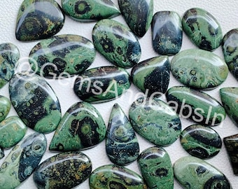 May include: A collection of 20 green and black polished gemstone cabochons. The cabochons have a swirling pattern of green, black, and white.