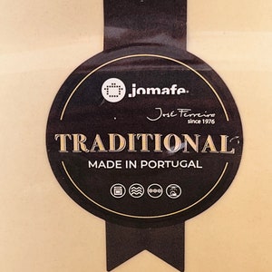 May include: A black and gold label with the text "jomafe. Jose Ferreira since 1976 TRADITIONAL MADE IN PORTUGAL" and icons for oven, microwave, freezer, and refrigerator.