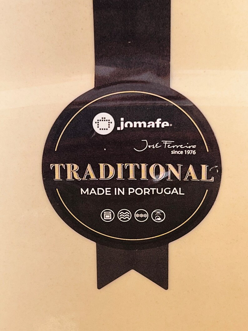 May include: A black and gold label with the text "jomafe. Jose Ferreira since 1976 TRADITIONAL MADE IN PORTUGAL" and icons for oven, microwave, freezer, and refrigerator.
