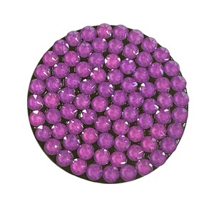 May include: A round, purple rhinestone embellishment with a black backing.