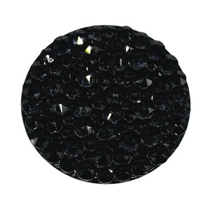 May include: A black round phone grip covered in small black rhinestones.
