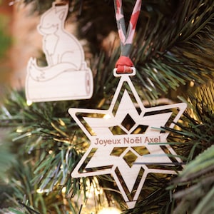 Wooden Star Tree Ornament personalized and engraved with the first name to hang with the festive decorations of the Christmas tree