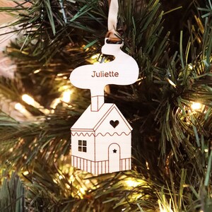 Personalized wooden “House” tree ornament engraved with the first name to hang with the festive decorations of the Christmas tree