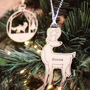 Personalized wooden “Reindeer” tree ornament engraved with the first name to hang with the festive decorations of the Christmas tree