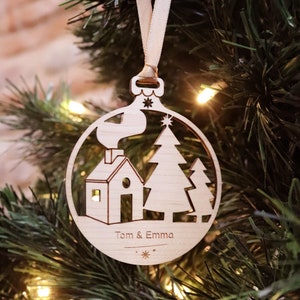 Personalized wooden “House” Christmas ball engraved with the first name to hang with the festive tree decorations