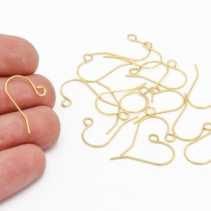 Puede incluir: Ganchos para pendientes de corazón de color dorado. Los ganchos son de metal y tienen un acabado liso.