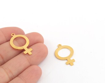 May include: Two gold-colored metal charms in the shape of the female gender symbol.