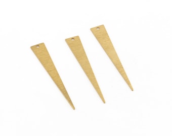 May include: Three gold-colored metal triangle shapes with a hole at the top. The triangles are pointed at the bottom and have a brushed finish.