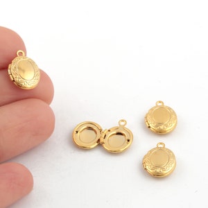 May include: Four gold-tone oval locket pendants with a decorative design. The lockets are open and closed.