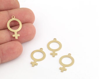 May include: Four gold-colored metal charms in the shape of the female gender symbol. The charms have a hole at the top for attaching to a necklace or bracelet.