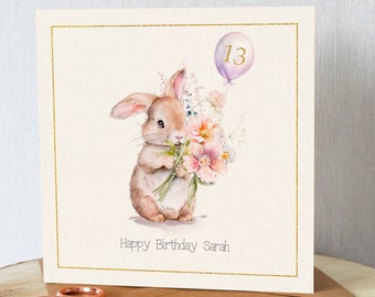 Personalised cute bunny rabbit birthday card. Add name (and age if required) Bunny Rabbit with flowers and balloon. Suitable any age.