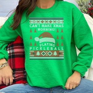 May include: Green Christmas sweater with a Santa hat and the text "Can't Make Xmas Morning! Playing Pickleball".