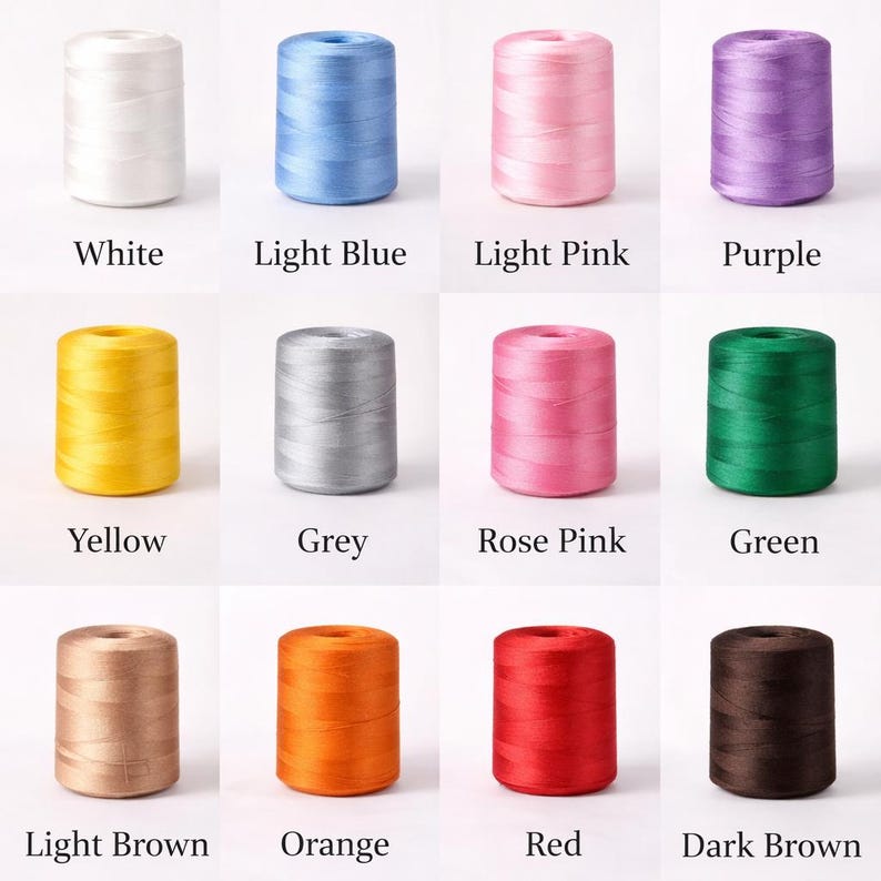 May include: A collection of colorful spools of thread, each labeled with its color: White, Light Blue, Light Pink, Purple, Yellow, Grey, Rose Pink, Green, Light Brown, Orange, Red, and Dark Brown. Ideal for sewing and crafting projects.