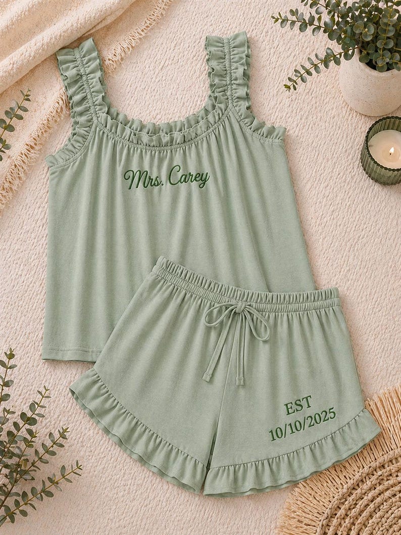 May include: Sage green pajama set with a ruffled tank top and matching shorts. The tank top has the embroidered text "Mrs. Carey". The shorts have a drawstring waist and the embroidered text "EST 10/10/2025".