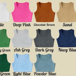 May include: A collection of crop tops in various colors, including white, deep pink, chocolate brown, and sand. Other colors are military green, ash grey, dark grey, navy blue, forest green, light blue, and powder blue. Each top has a scoop neck.