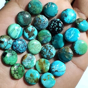 May include: A collection of turquoise gemstone beads in various shades of blue and green. The beads are round and polished, with unique patterns and textures. Some beads have brown matrix inclusions, adding to their natural beauty. These beads are perfect for jewelry making.