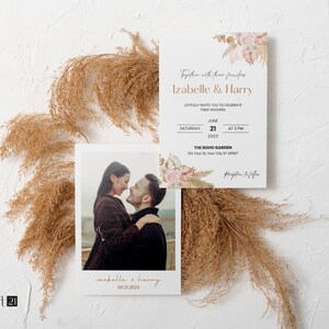 May include: Wedding invitation suite featuring a photo card and invitation with text "Izabelle & Harry". The invitation includes details for the wedding on June 21, 2023, at 3 PM. The design incorporates floral elements and a boho theme.