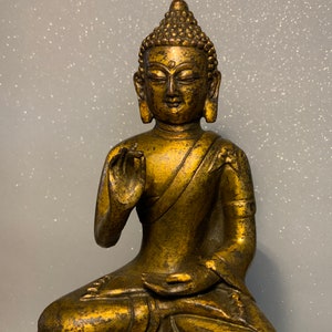 An  antique bronze and gilt Buddha statue