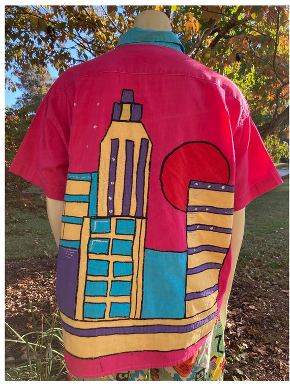 1980s hot pink shirt with cityscape on back