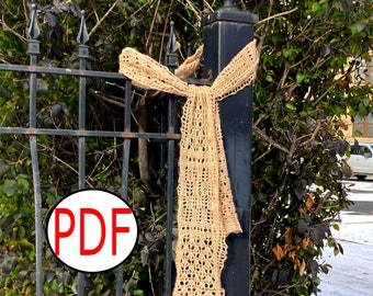 May include: A beige, open-weave scarf is draped over a black metal fence post. The scarf has a delicate, lacy pattern and is tied in a bow at the top. The word "PDF" is in a red circle in the lower left corner.