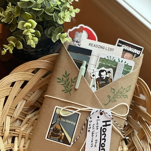 Wrapped blind date with a book in the Horror genre with horror-themed stickers and colors.